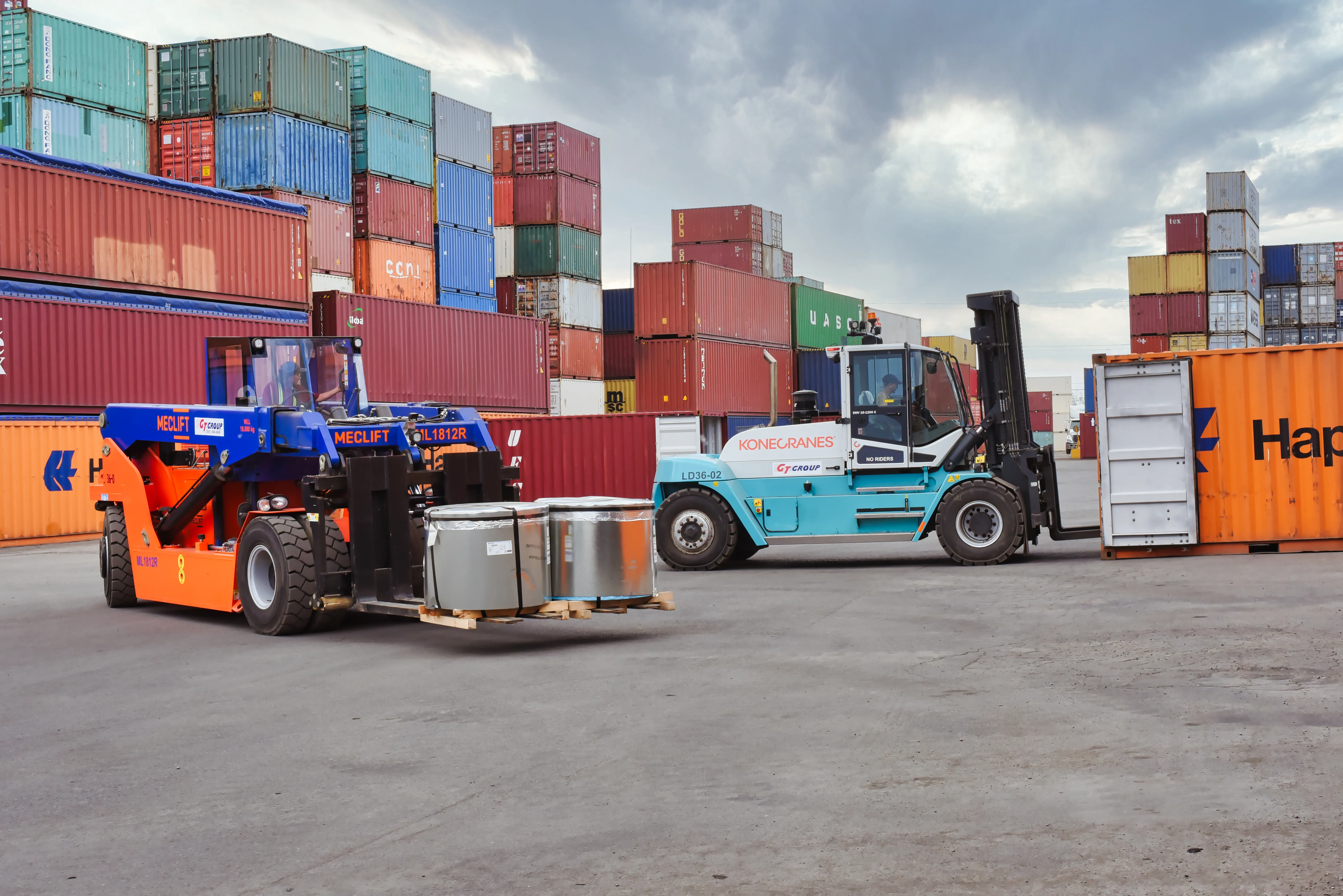 GT Group Meclift and Konecranes forklifts handling steel coils in the container yard