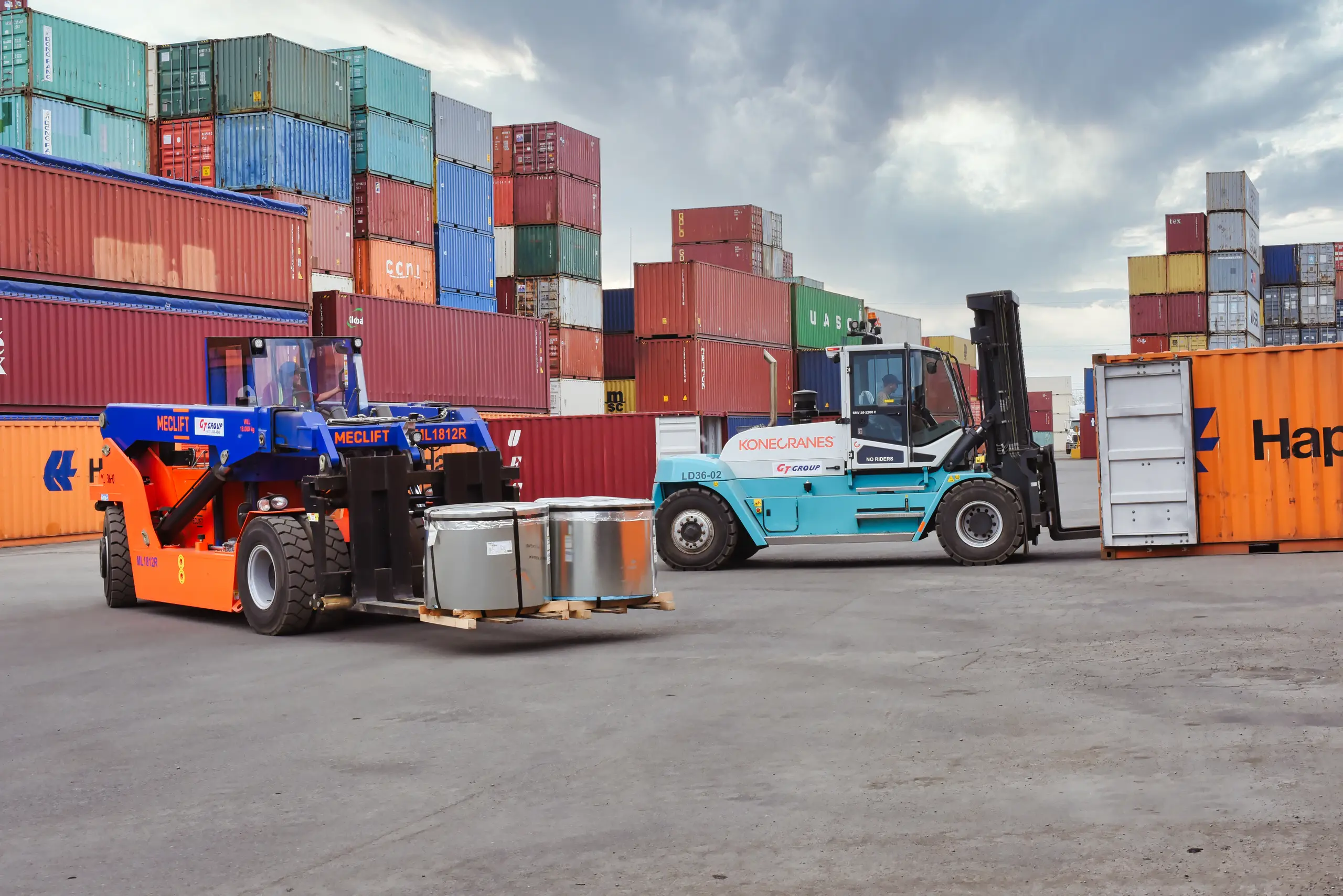 GT Group Meclift and Konecranes forklifts handling steel coils in the container yard